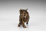 Rear view of a realistic bronze bull sculpture featuring a flowing tail and handcrafted finish.