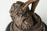 Detailed bronze Goliath head beneath David's foot