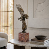 Mythic bronze eagle sculpture diving over waves. A powerful statement piece symbolizing strength, freedom, and mastery of the elements.
