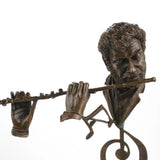 Close-up detail of a handcrafted bronze flutist sculpture showing the flute, hands, and hand-finished bronze patina.