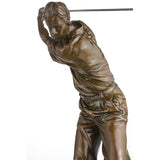 Close-up detail of bronze golfer sculpture showing facial expression, hands, and golf club.