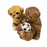 Two bronze playful pug puppies gathered around a soccer ball in a charming decorative dog sculpture