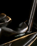 Detail of tall mast on abstract bronze sailing sculpture with minimalist nautical styling