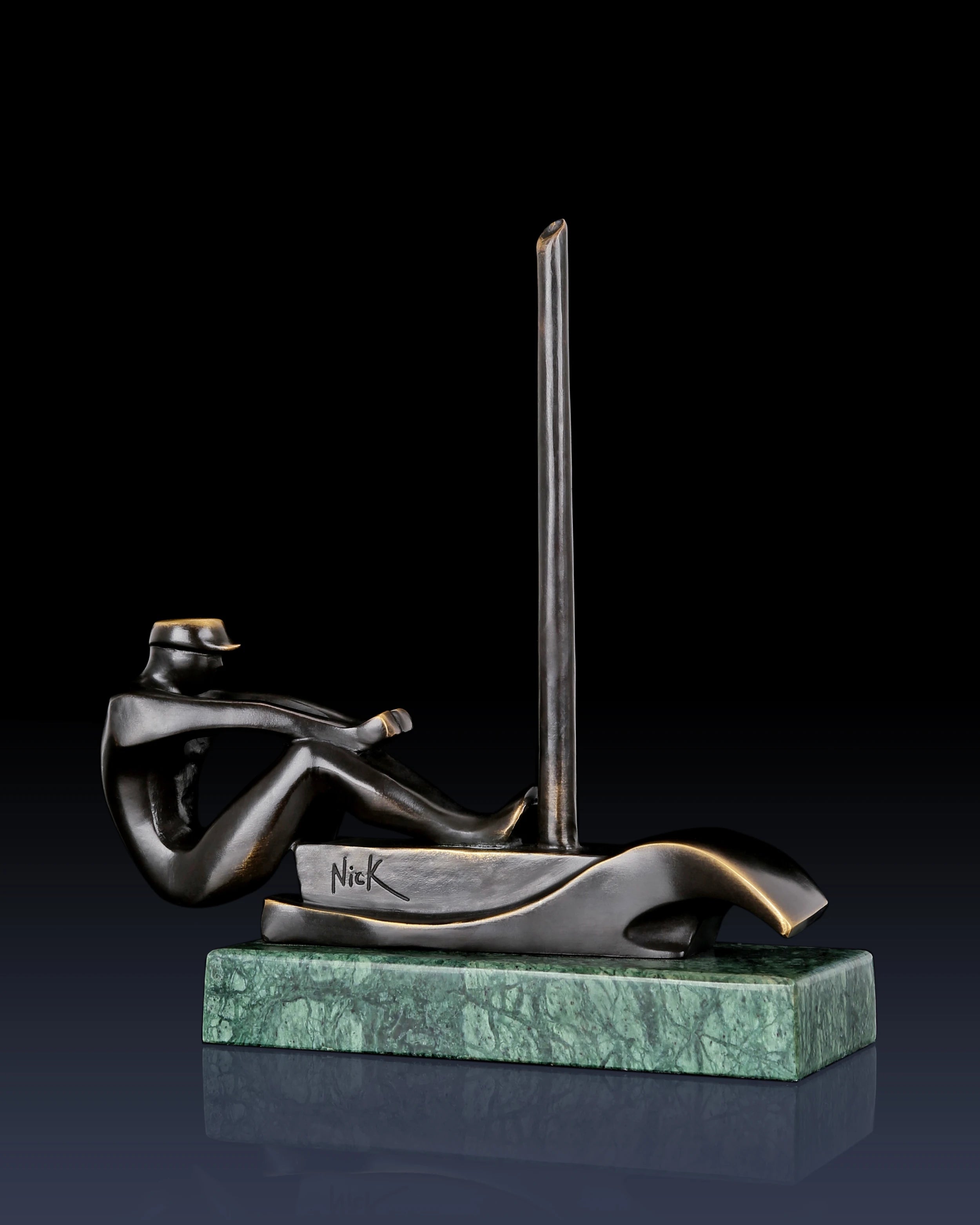 Left side view of bronze sailing sculpture with stylized sailor and contemporary boat design