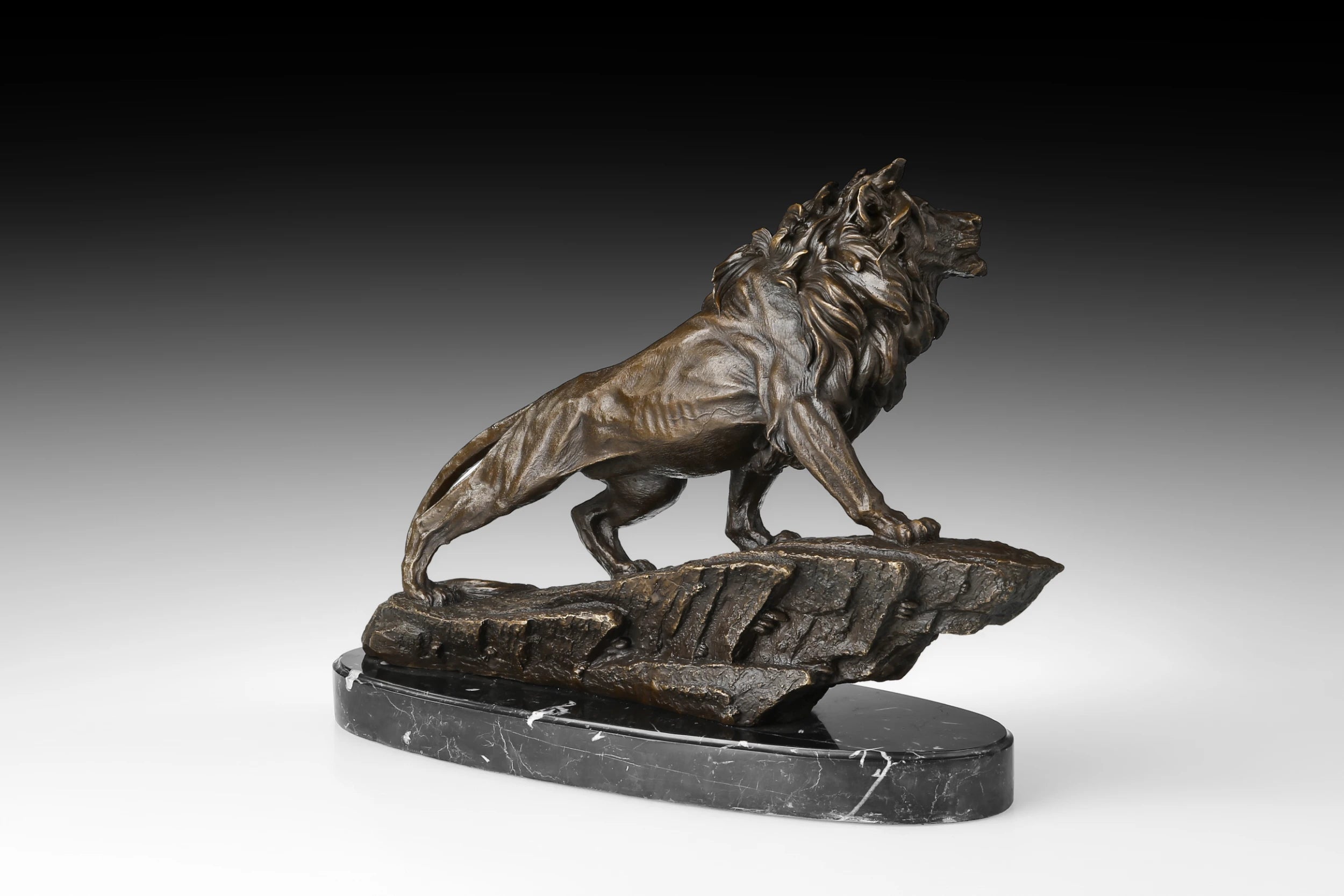 Close-up of bronze striding lion showing powerful shoulders, musculature, and sculpted surface texture