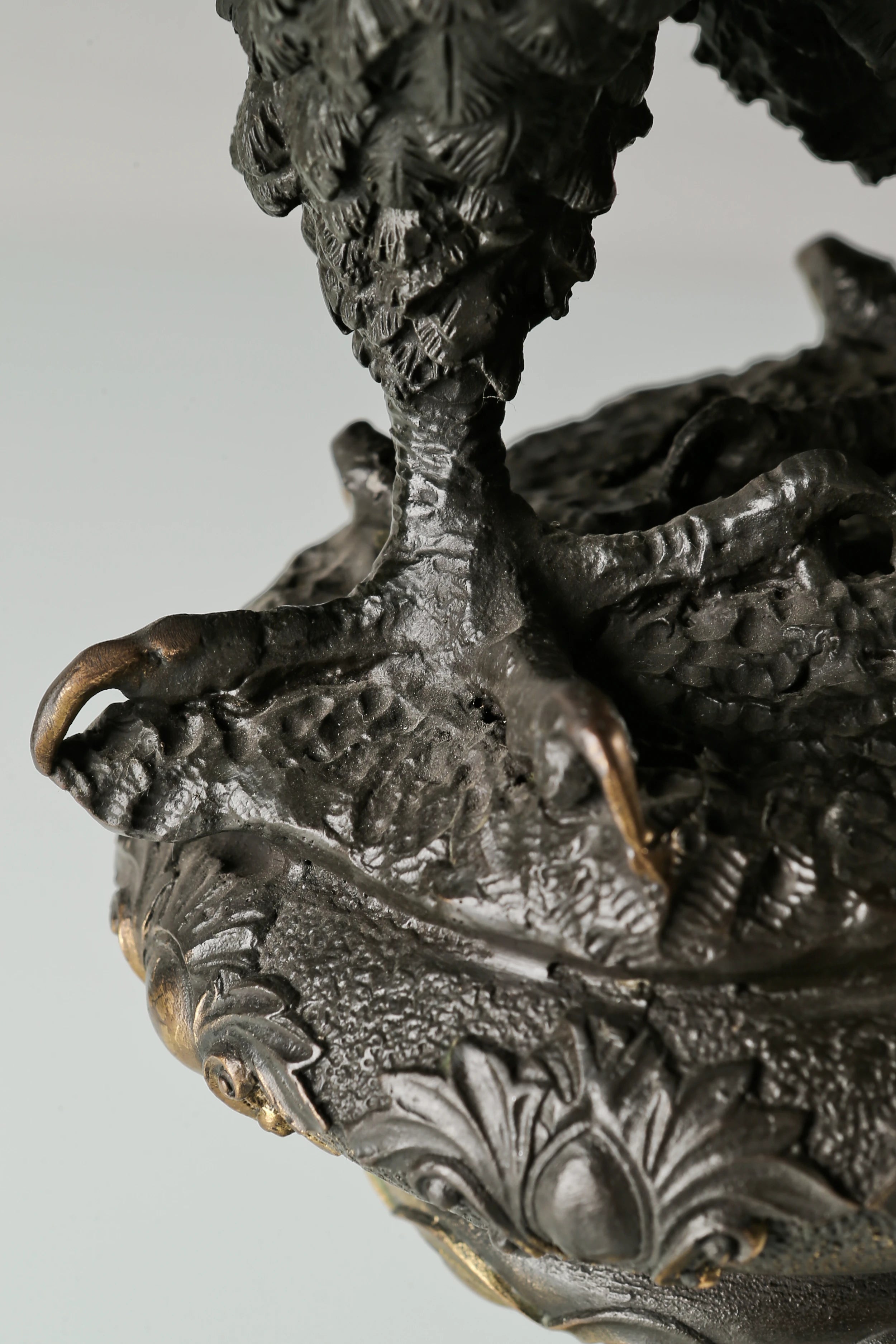 Bronze eagle statue with wings partially spread and decorative base. Classical wildlife sculpture for home decor, office, or collectors.
