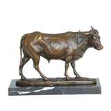 Realistic walking bronze bull sculpture with detailed anatomy and aged patina, walking animal statue on veined black marble base, loss wax casting fine art.
