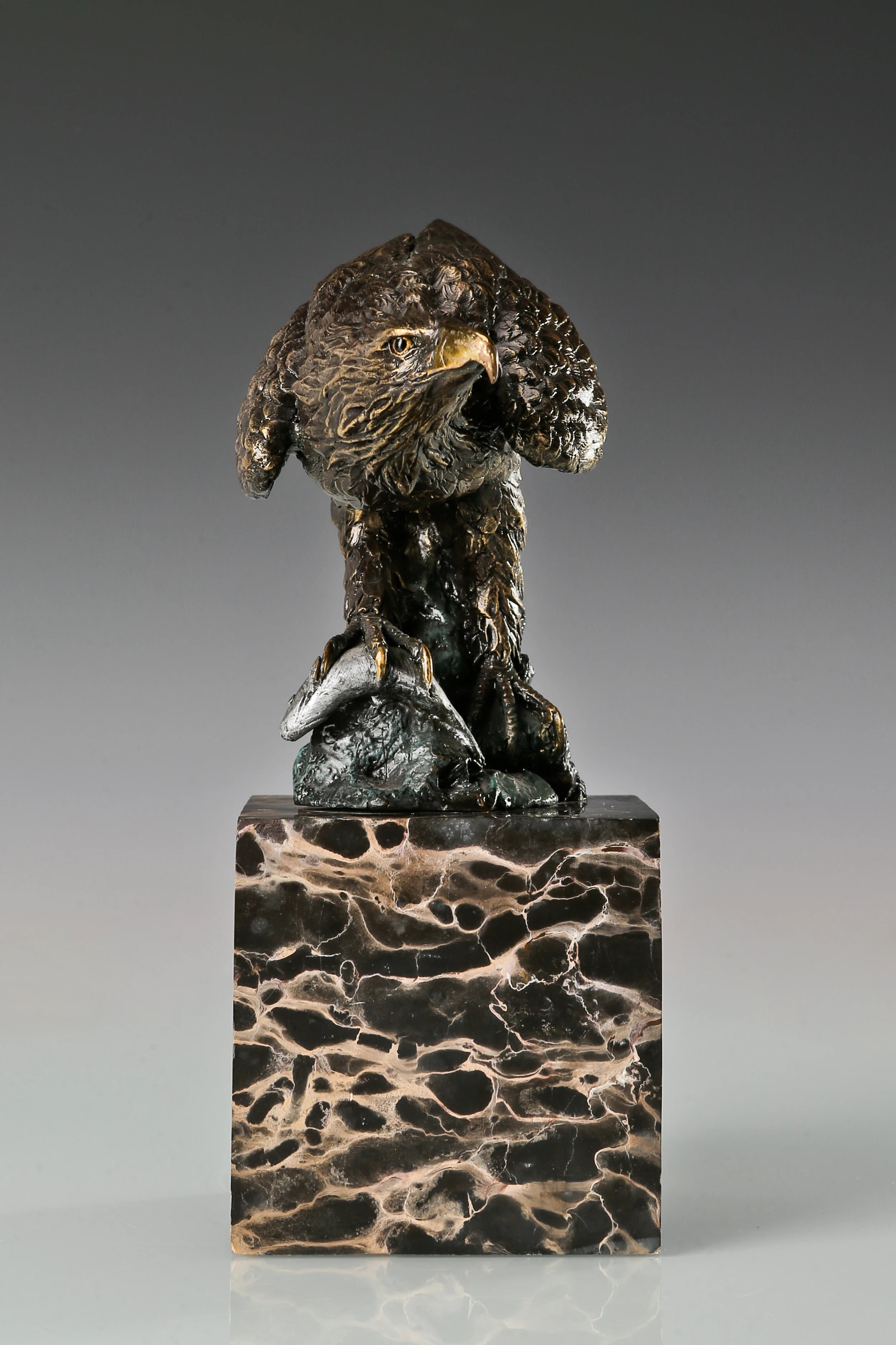 Pre-flight bronze eagle sculpture with detailed feathers and natural base. Elegant wildlife statue for home decor, office, or collectors.