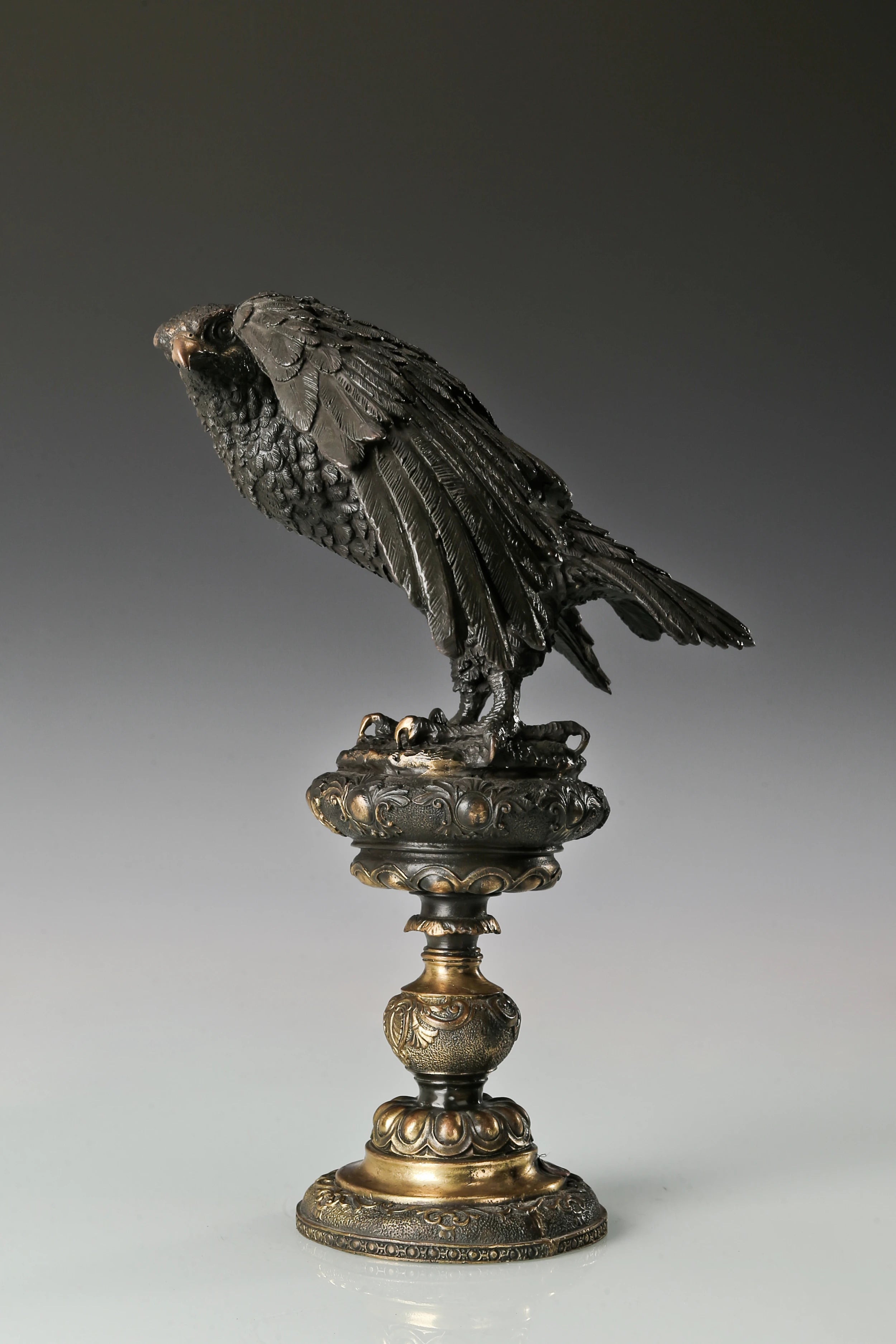 bronze eagle statue with ornate base