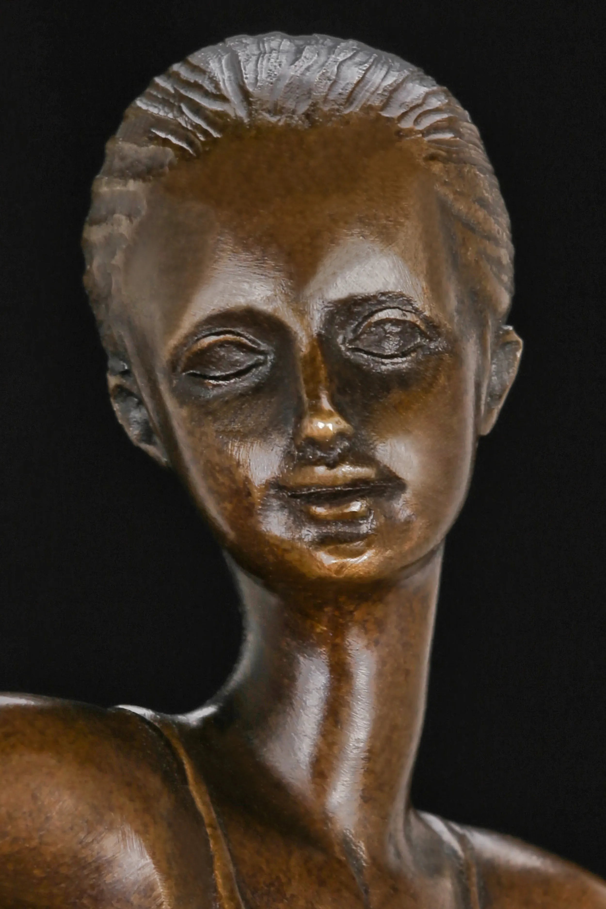 Close-up of the ballerina bronze sculpture showing her delicate facial expression