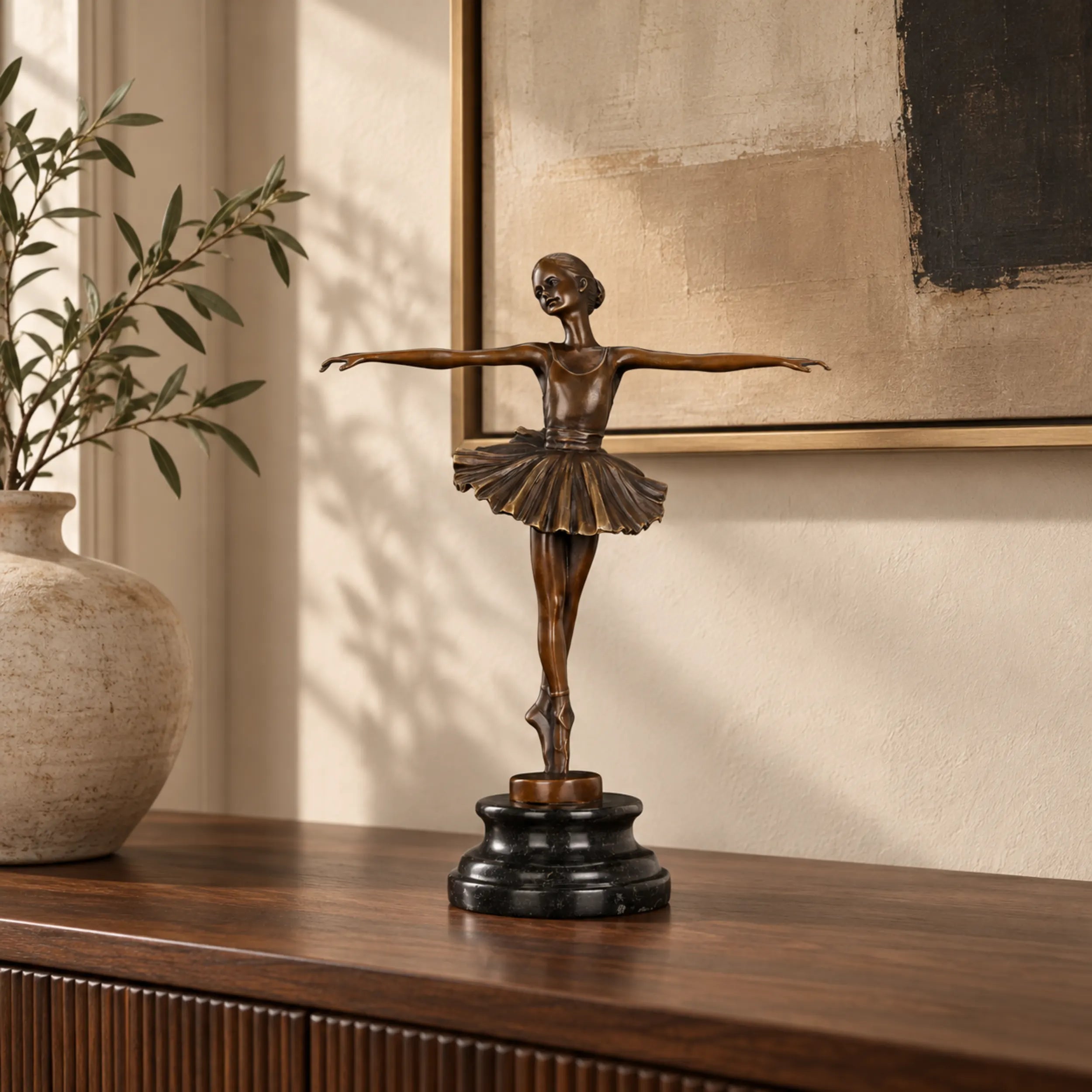 Classical ballerina bronze sculpture displayed on a console table in an elegant living room