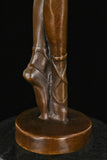 Close-up of ballerina bronze sculpture showing pointe shoes and balanced foot position