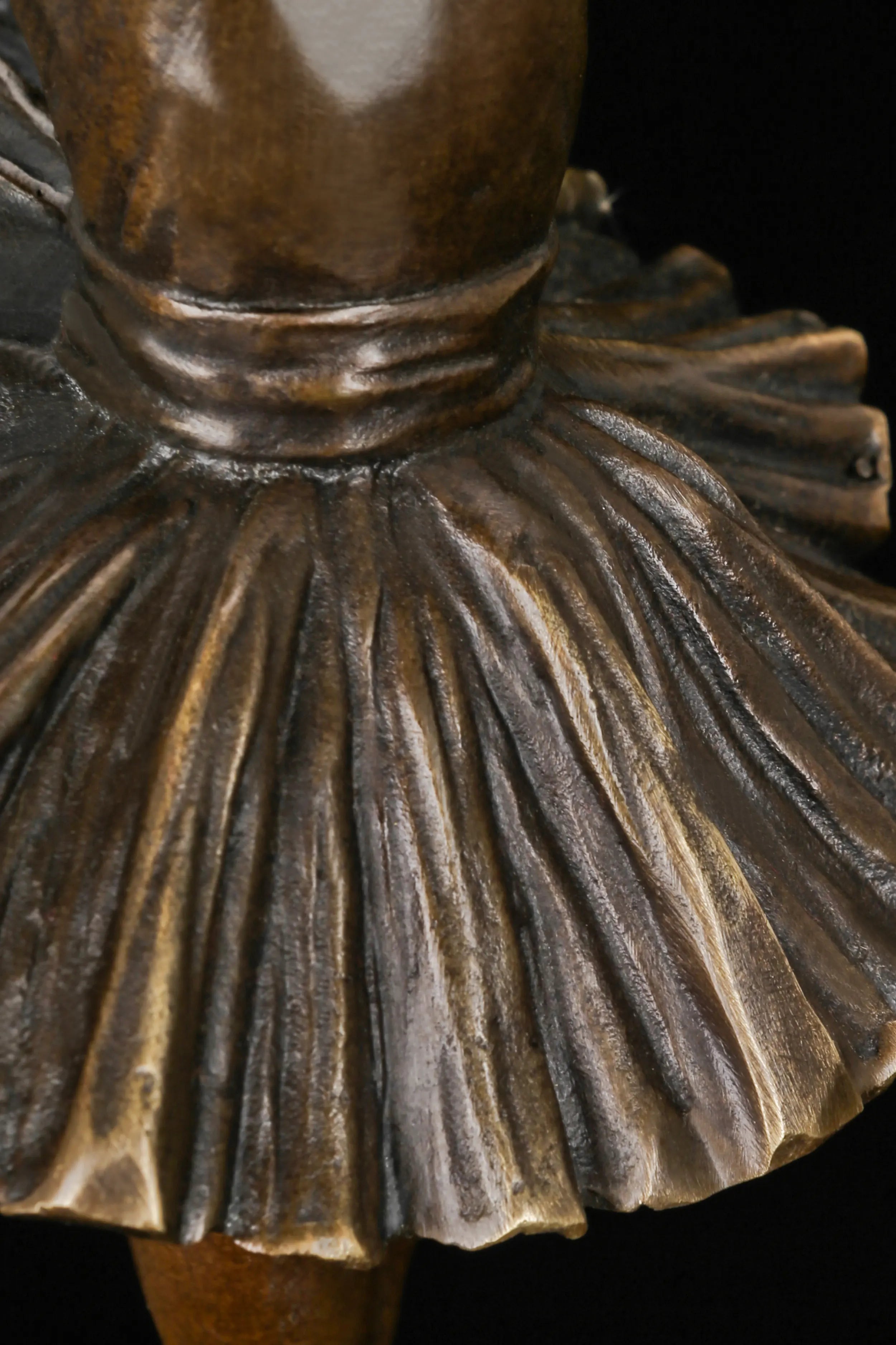 Detailed view of the pleated classical ballet tutu on the bronze ballerina sculpture