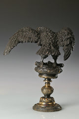 Elegant bronze eagle sculpture with ornate pedestal and detailed feathers. A refined statement piece symbolizing strength, control, and authority.