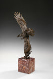 Mythic bronze eagle sculpture diving over waves. A powerful statement piece symbolizing strength, freedom, and mastery of the elements.