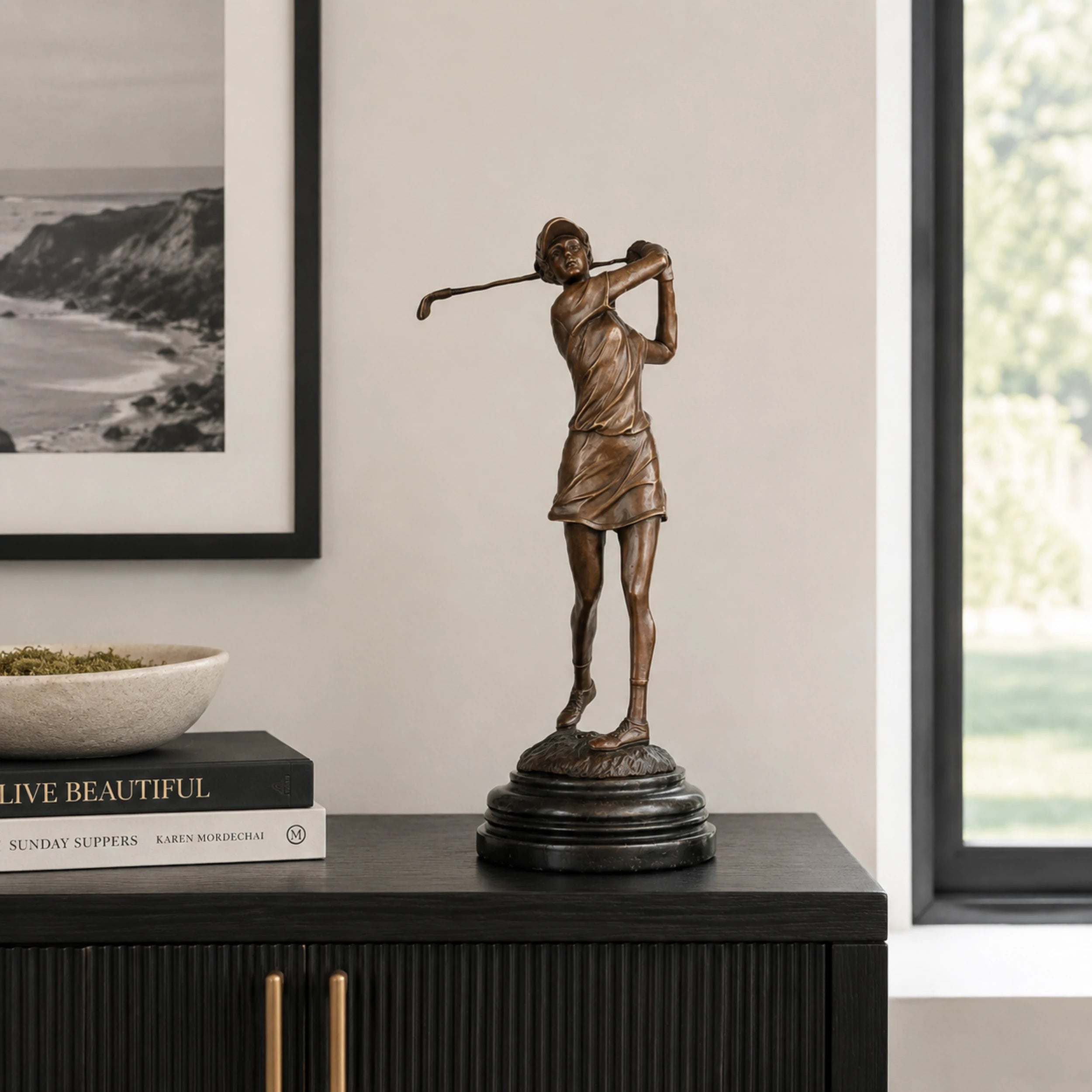 Female Golfer Follow-Through Bronze Sculpture displayed in a modern interior