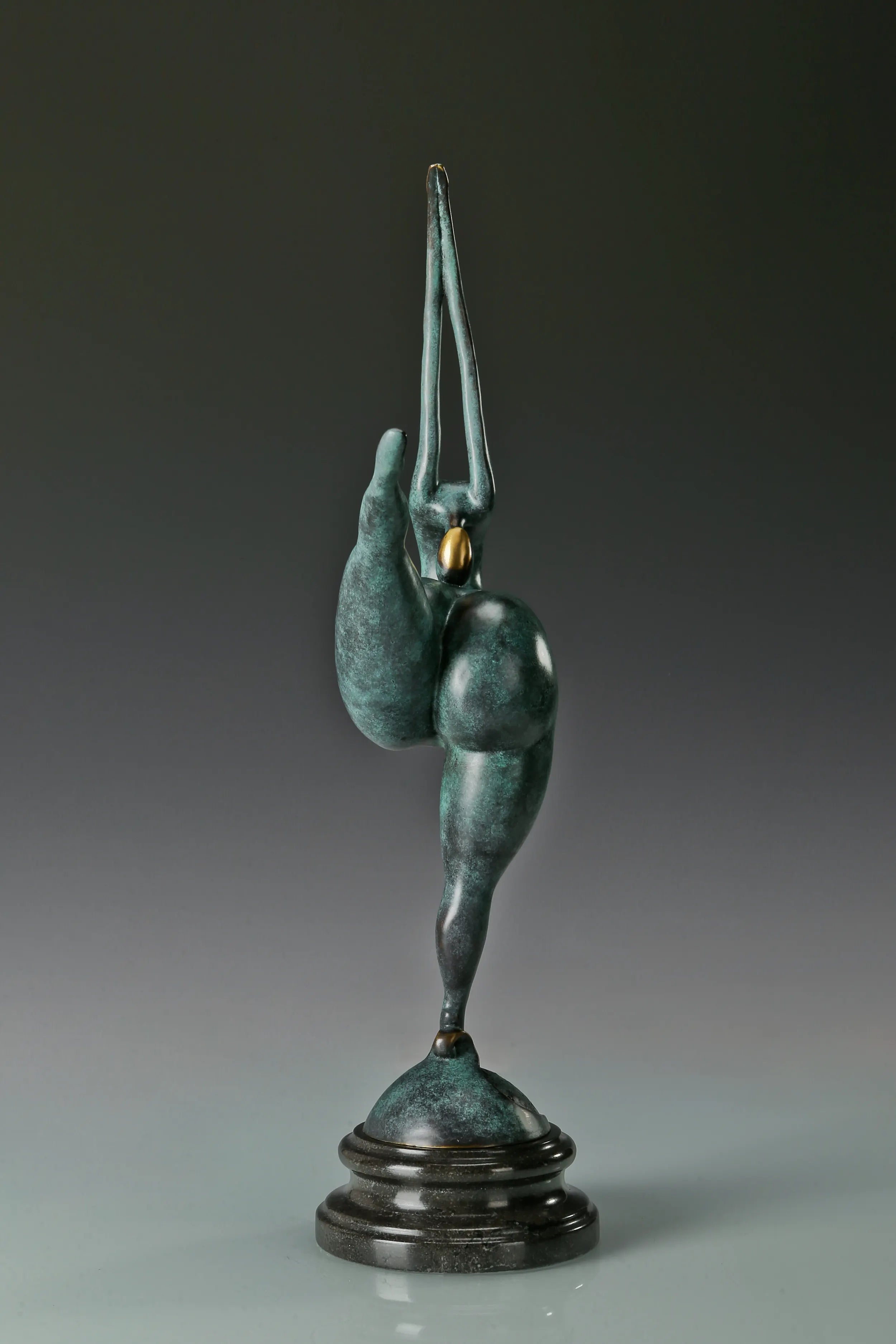 Rear view of female gymnast bronze sculpture in a one-legged balancing pose