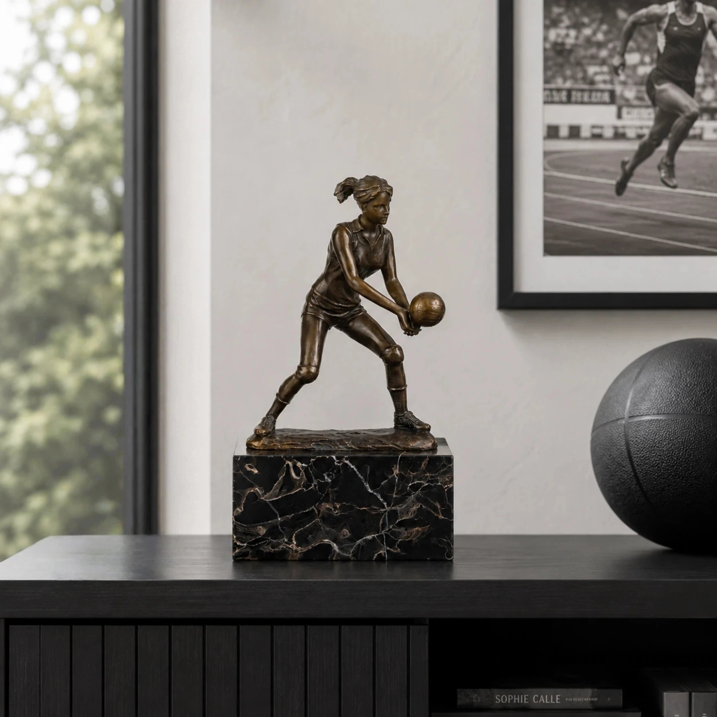 Female volleyball Player Bronze Sculpture displayed in a modern interior
