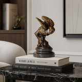 A bronze owl statue capturing the powerful moment of flight. Detailed feather textures and a black marble base make this wildlife statue perfect for home or office decor.