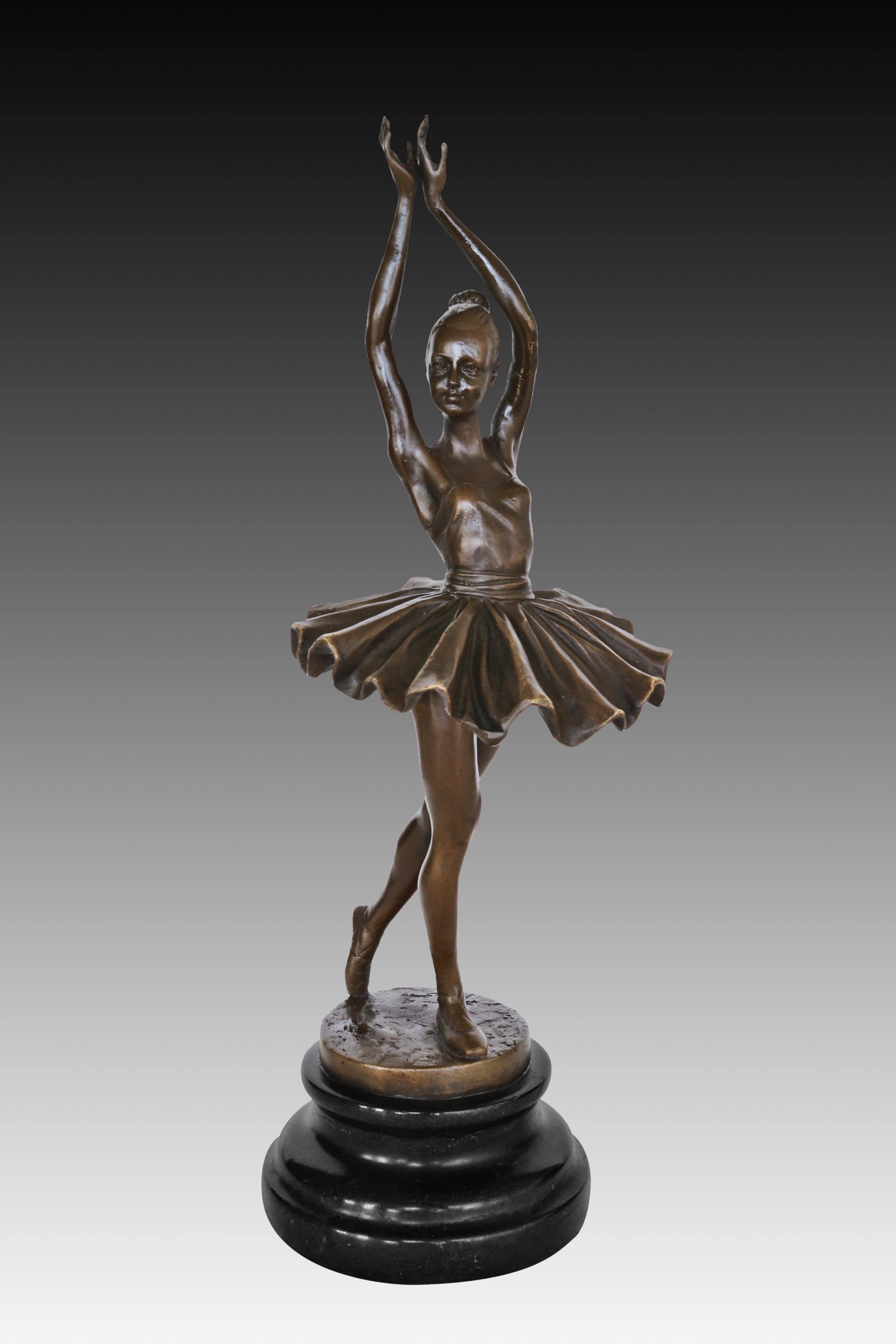 handcrafted ballerina bronze statue showing the elegant dance pose and detailed tutu