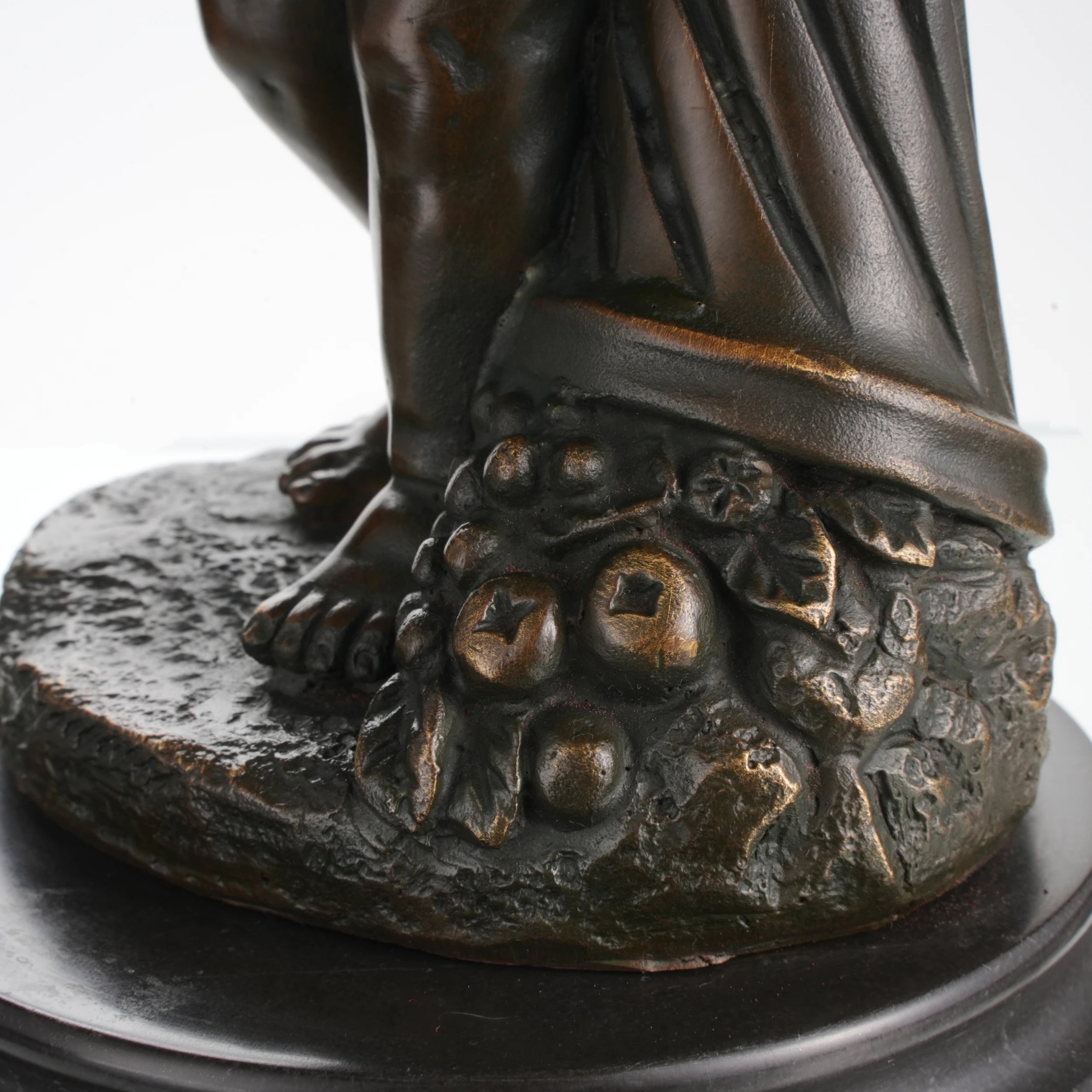 Grapes and fruit carving detail in bronze statue