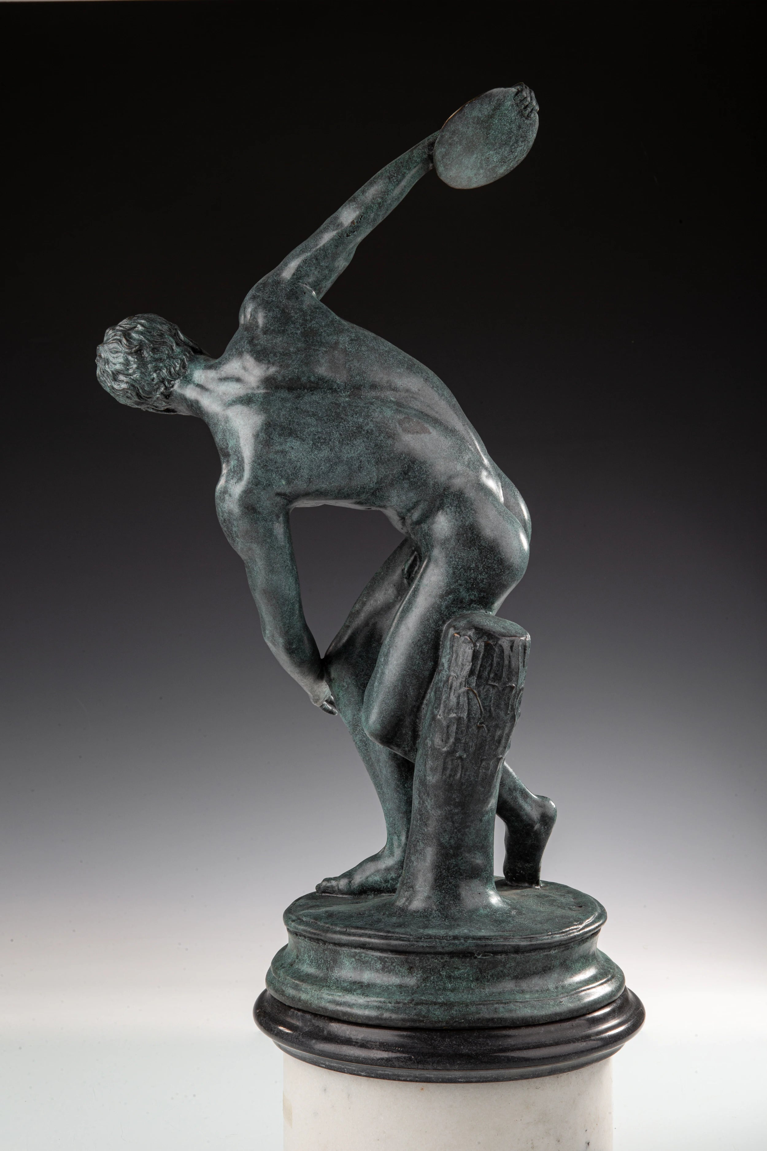 Classical Discobolus bronze sculpture inspired by ancient Greek art. A timeless discus thrower statue symbolizing athleticism, balance, and beauty.