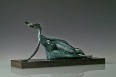 Profile of green patina bronze woman sculpture resting on her side