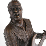 Close-up of guitarist facial expression in bronze sculpture