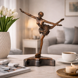 This is an elegant bronze sculpture of a figure skater, crafted using the lost-wax casting method. The piece captures the athlete mid-performance, striking a graceful pose with one leg extended high behind her and arms outstretched, conveying poise, balance, and fluid movement. The rich, warm bronze patina accentuates the delicate folds of her dress, the intricate details of her ice skates, and the smooth, flowing lines of her form.