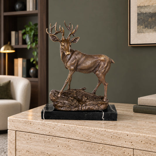 Handcrafted bronze stag sculpture featuring detailed antlers and naturalistic base. Lost-wax cast deer statue on marble base, ideal for luxury home decor.