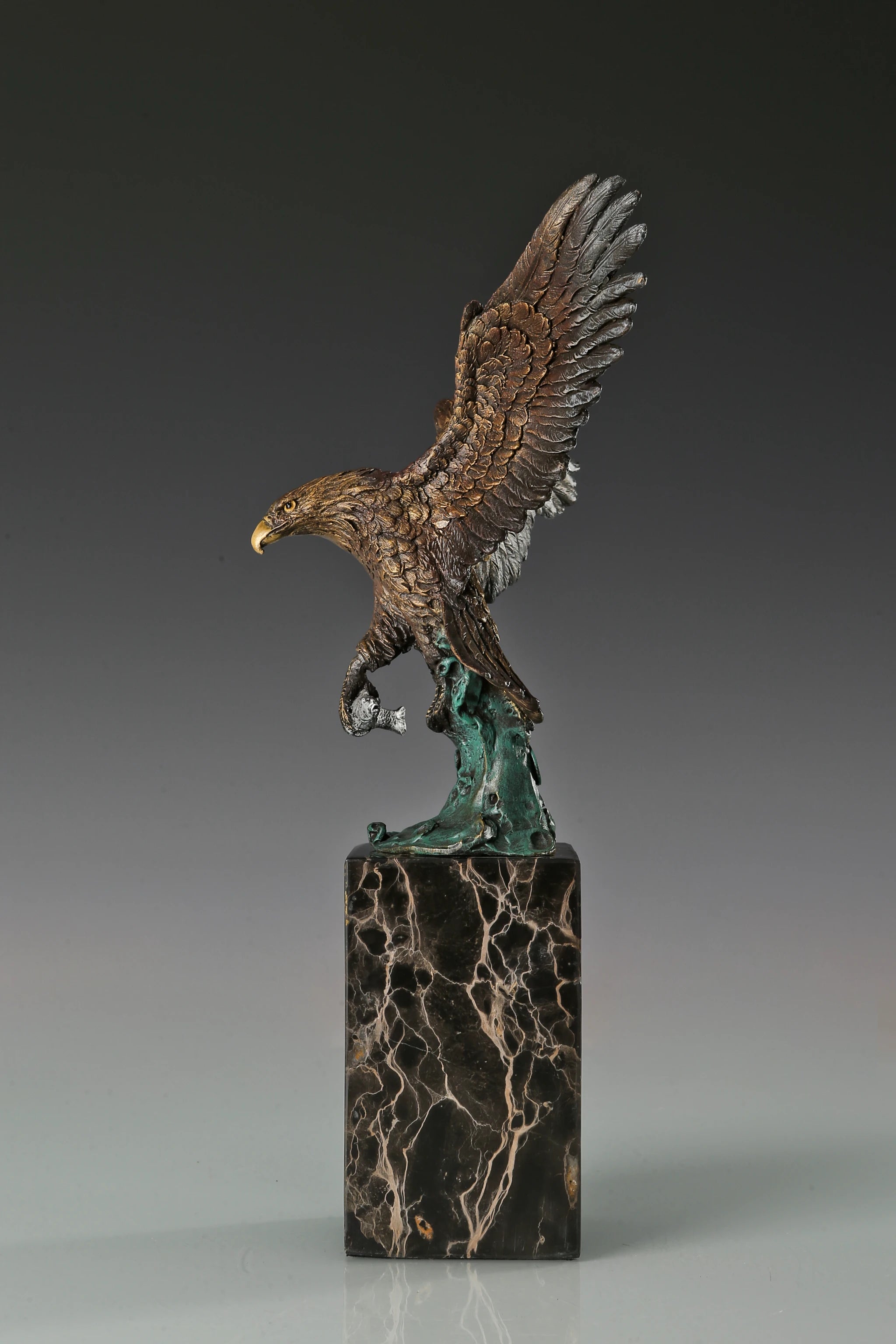 Handcrafted bronze eagle sculpture featuring spread wings and detailed feathers. Mounted on a marble base, this striking wildlife statue symbolizes strength, freedom, and prestige.