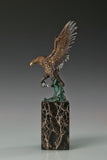 Handcrafted bronze eagle sculpture featuring spread wings and detailed feathers. Mounted on a marble base, this striking wildlife statue symbolizes strength, freedom, and prestige.
