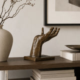 Helping Hand Surreal Bronze Sculpture displayed in a styled interior
