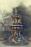 Front view of bronze Four Seasons fountain featuring seated goddesses and horses