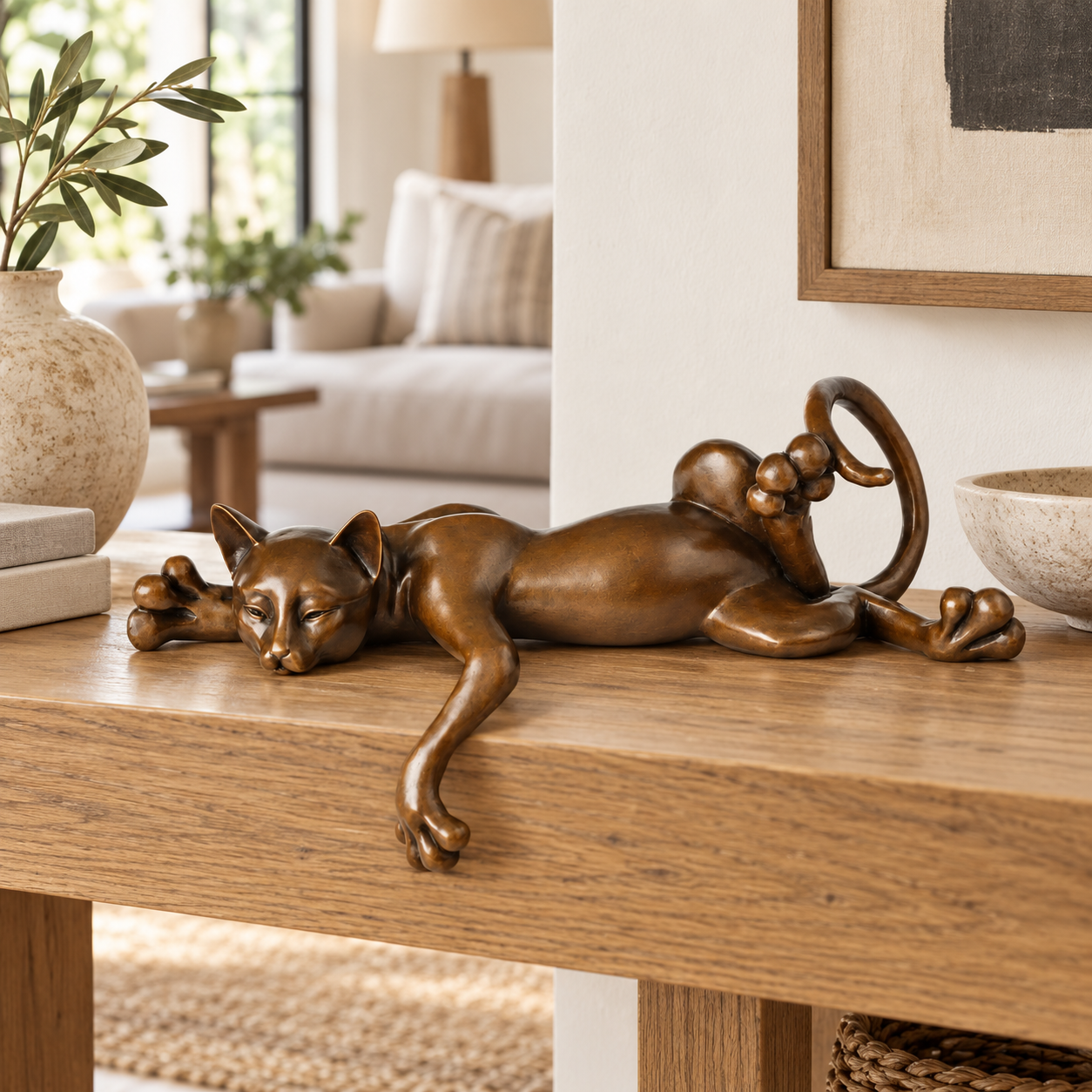 Lazy Sleeping Cat bronze sculpture displayed in a minimalist interior