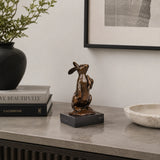 Looking-Up Rabbit Bronze Sculpture displayed in a styled interior