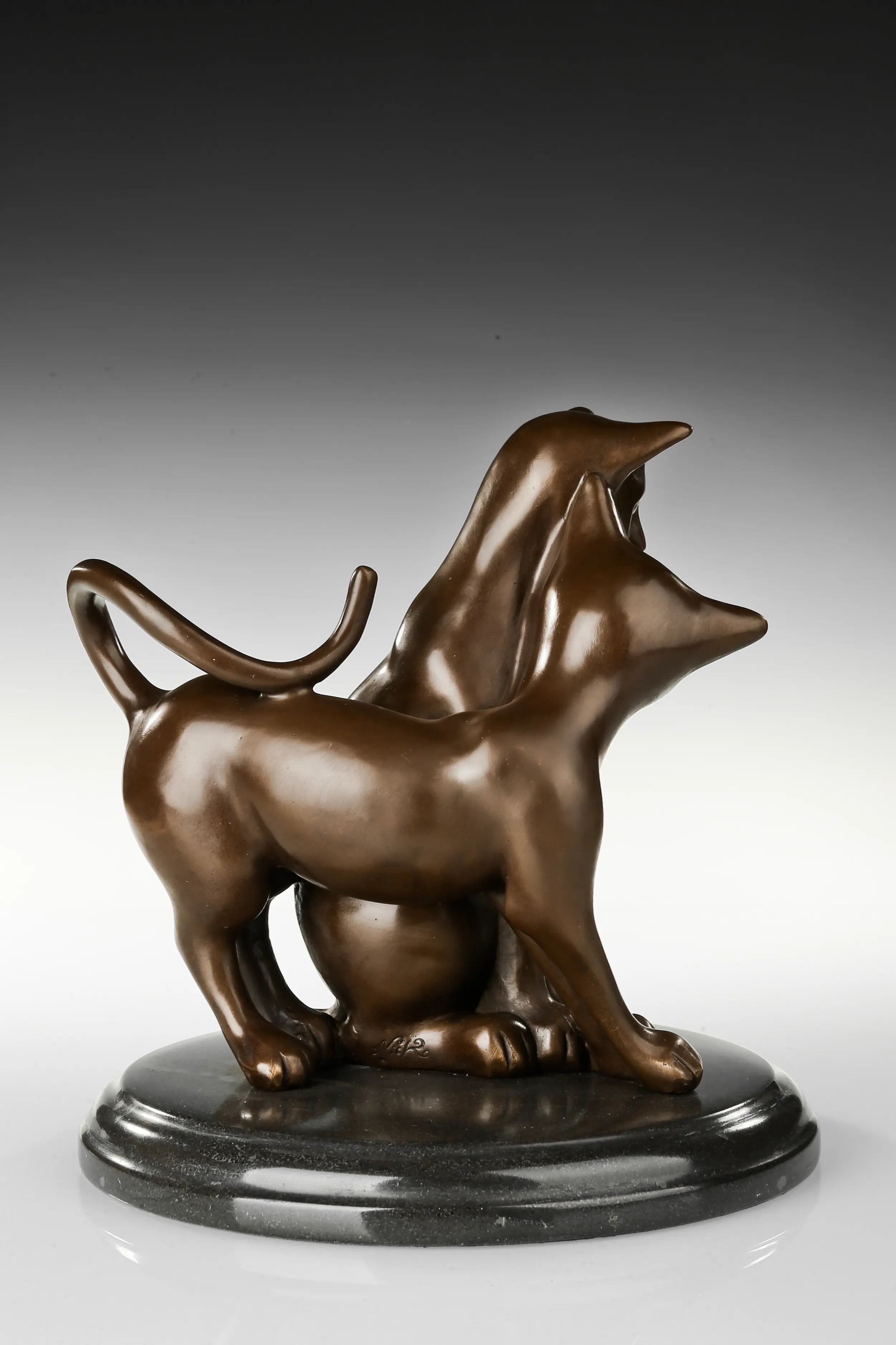 Back view of loving cats bronze sculpture showing intertwined forms