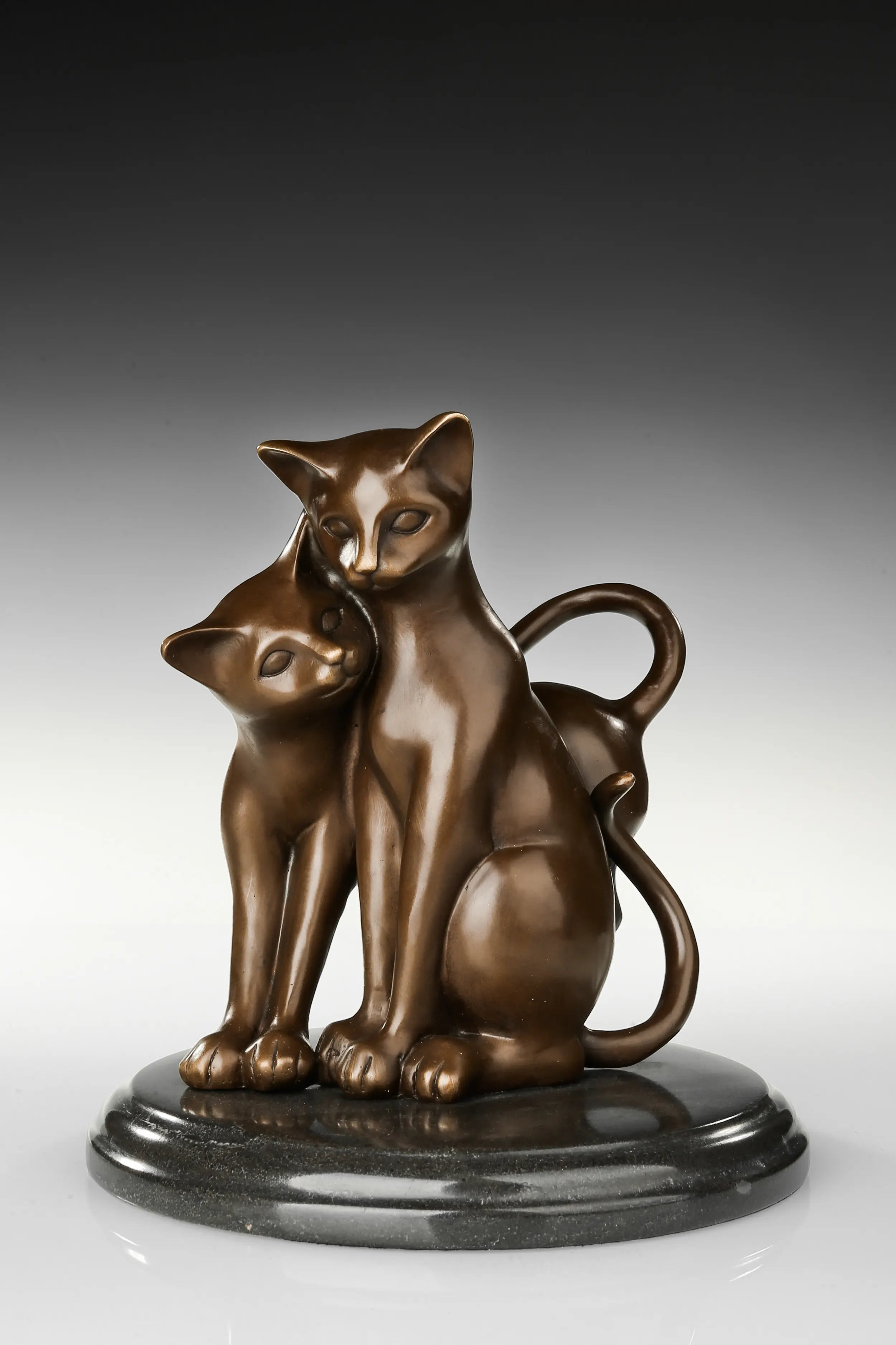 Close-up of the warm bronze patina and smooth finish on the cat sculpture