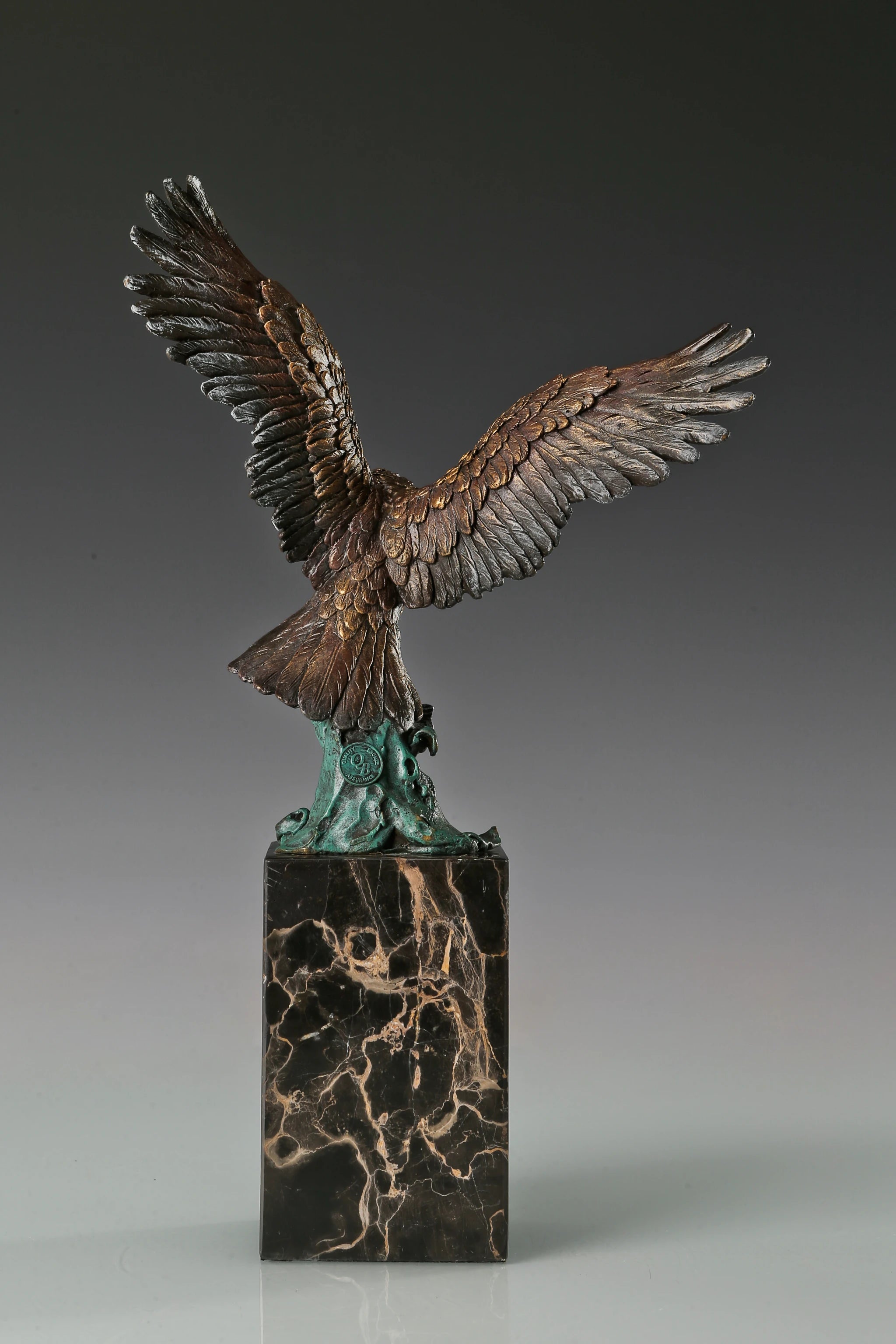 Handcrafted bronze eagle sculpture featuring spread wings and detailed feathers. Mounted on a marble base, this striking wildlife statue symbolizes strength, freedom, and prestige.