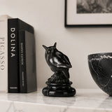 a modern abstract bronze owl sculpture with smooth minimalist lines and a black marble base. A stylish symbol of wisdom, perfect for contemporary home or office decor.