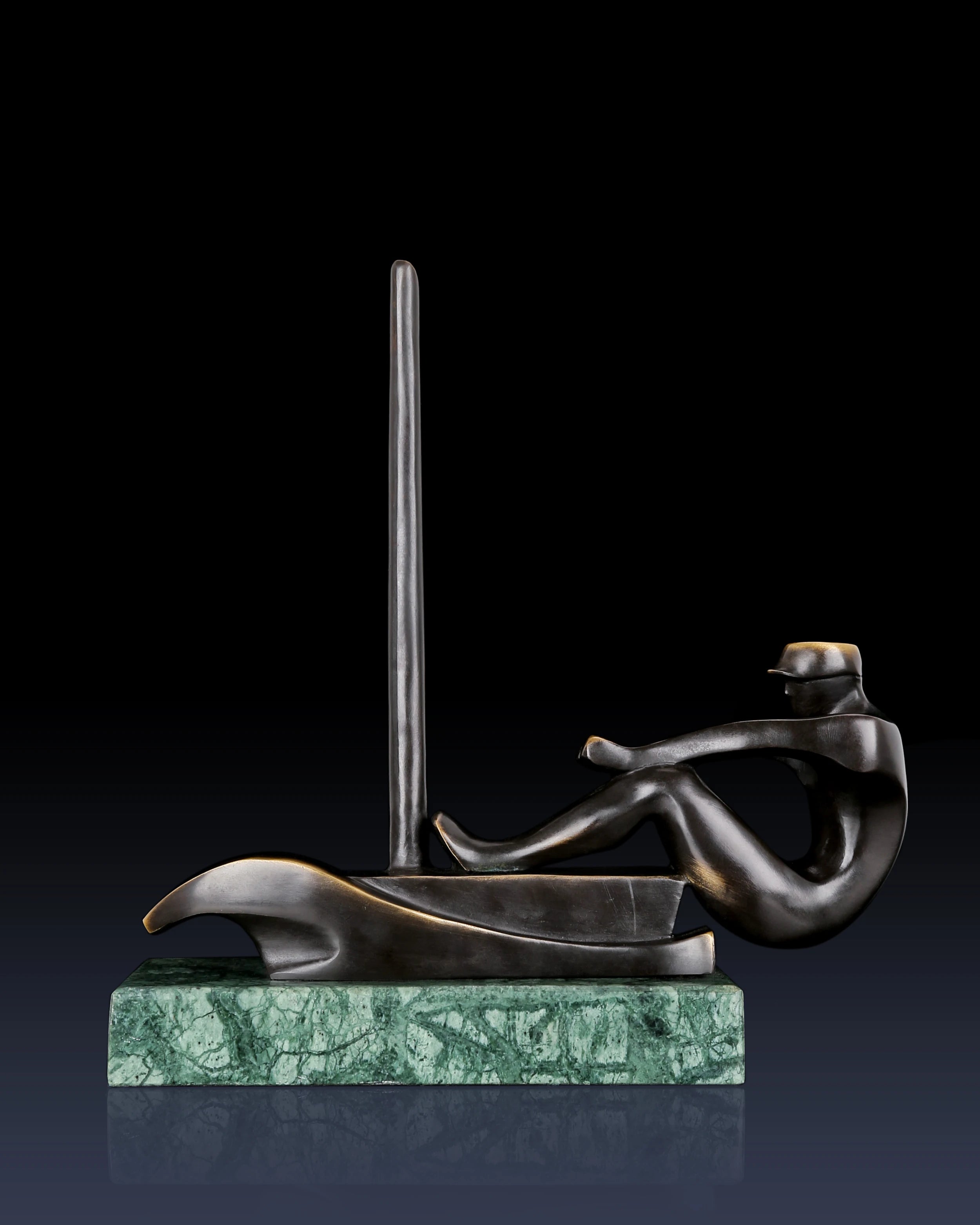 Right side view of modern bronze sailboat sculpture with streamlined artistic design