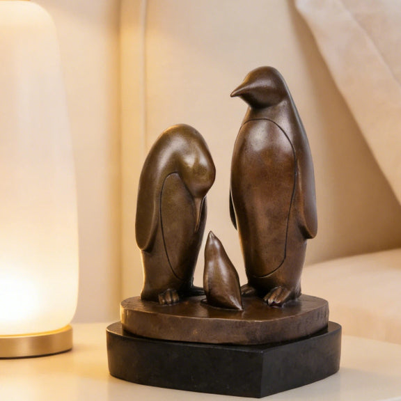 This penguin family bronze sculpture captures a tender moment between three penguins, rendered in clean, minimalist lines that emphasize form, balance, and emotional connection. Expertly crafted from solid bronze, the sculpture features a warm, natural finish that enhances its timeless character and tactile appeal.