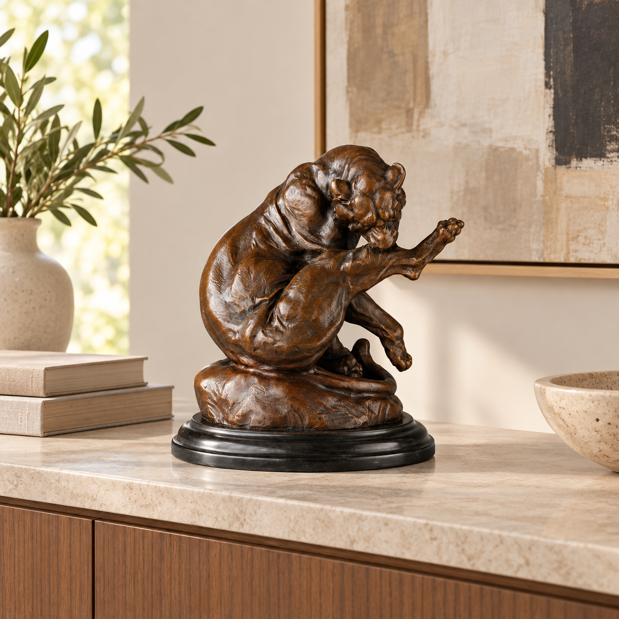 Playful Seated Lion Bronze Sculpture displayed in a minimalist interior