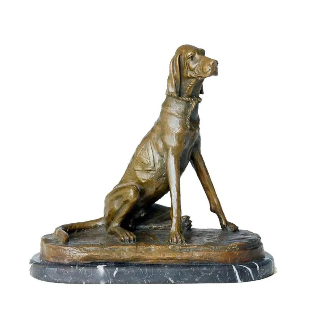 This stately bronze sculpture of a seated pointer dog is crafted using the traditional lost-wax casting method. The dog is portrayed in an alert upright pose, with its head slightly turned, expressing focus and refined poise characteristic of a hunting breed. The warm bronze patina highlights its lean musculature, smooth short coat, and detailed rope collar.