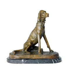 This stately bronze sculpture of a seated pointer dog is crafted using the traditional lost-wax casting method. The dog is portrayed in an alert upright pose, with its head slightly turned, expressing focus and refined poise characteristic of a hunting breed. The warm bronze patina highlights its lean musculature, smooth short coat, and detailed rope collar.