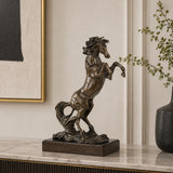 powerful rearing bronze horse statue with raised front legs and flowing mane, realistic stallion statue on black marble base, loss wax casting fine art.