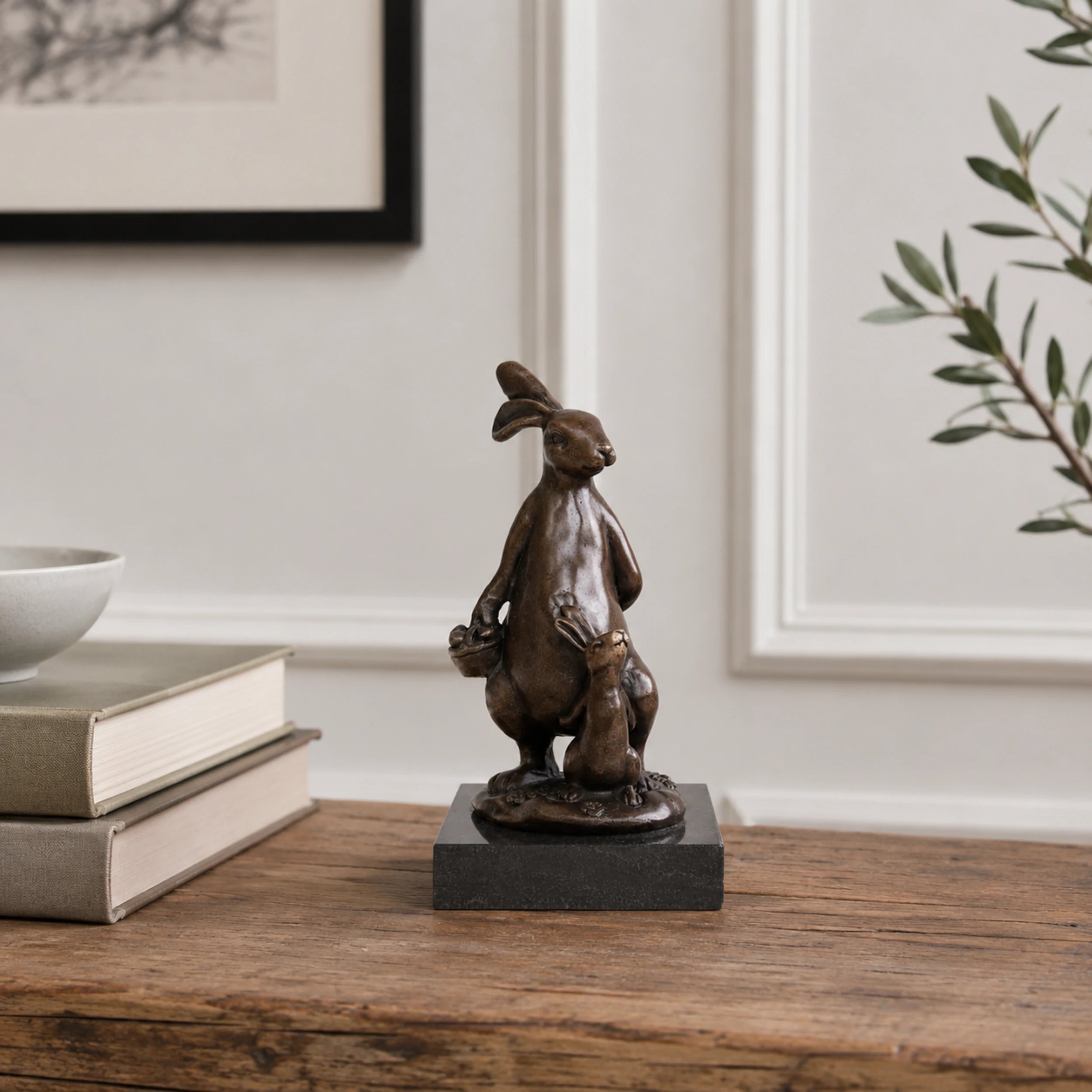 Rabbit Holding Acorn Bronze Sculpture displayed in a styled interior