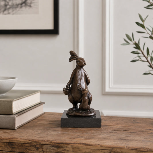 Rabbit Holding Acorn Bronze Sculpture displayed in a styled interior
