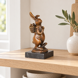 Rabbit with Basket Bronze Sculpture displayed in a minimalist interior
