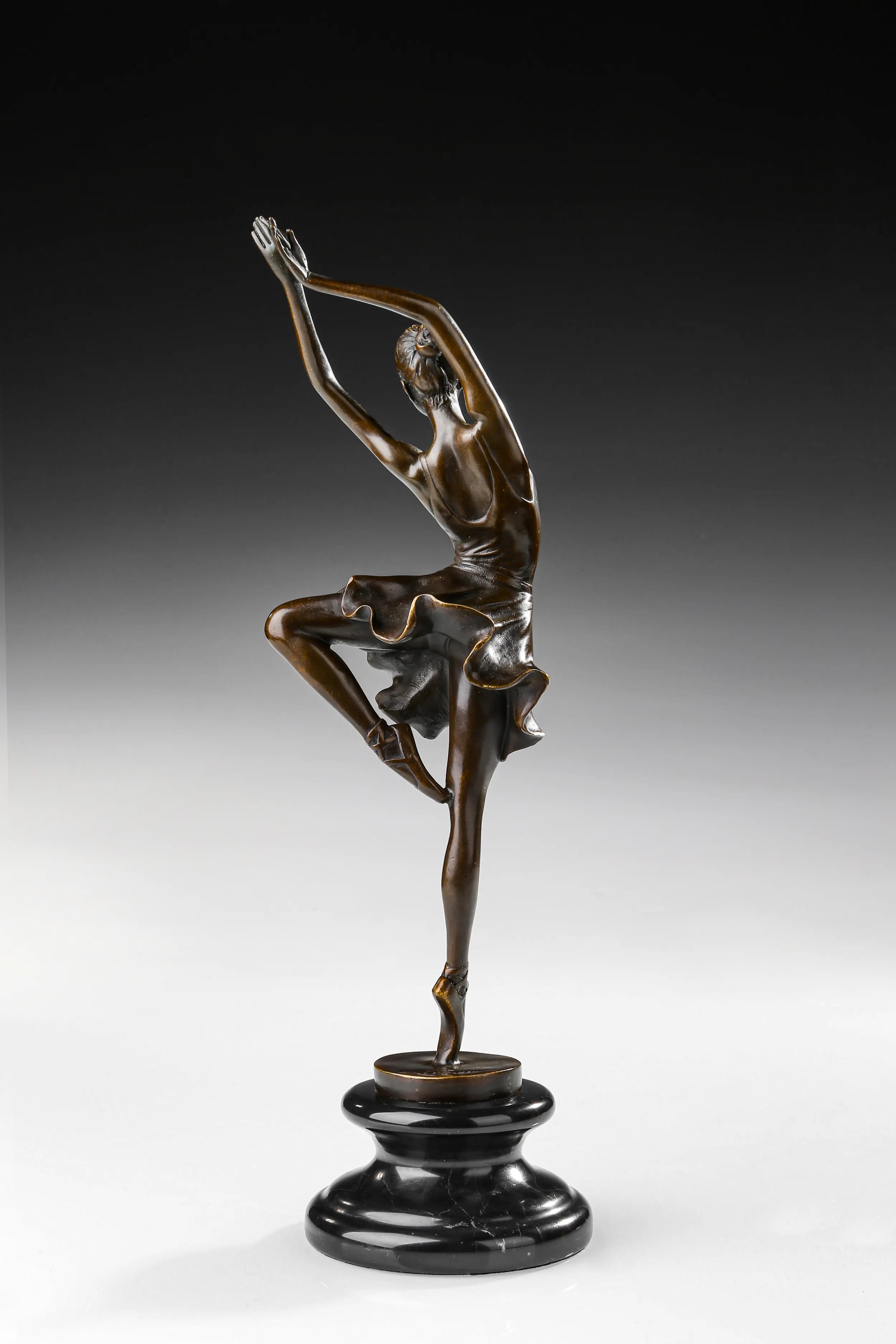 Back view of handcrafted ballerina bronze sculpture with overhead arms